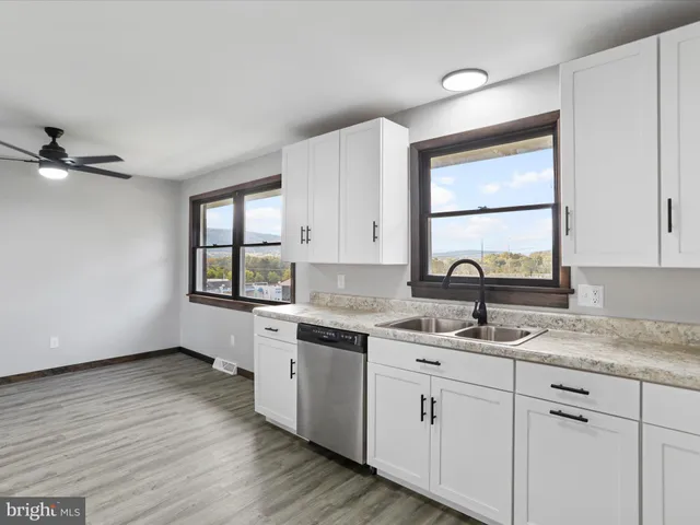 a kitchen with a sink cabinets and window