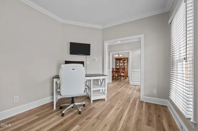a view of a workspace with furniture and a window