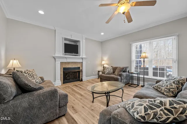 a living room with furniture a fireplace and a flat screen tv