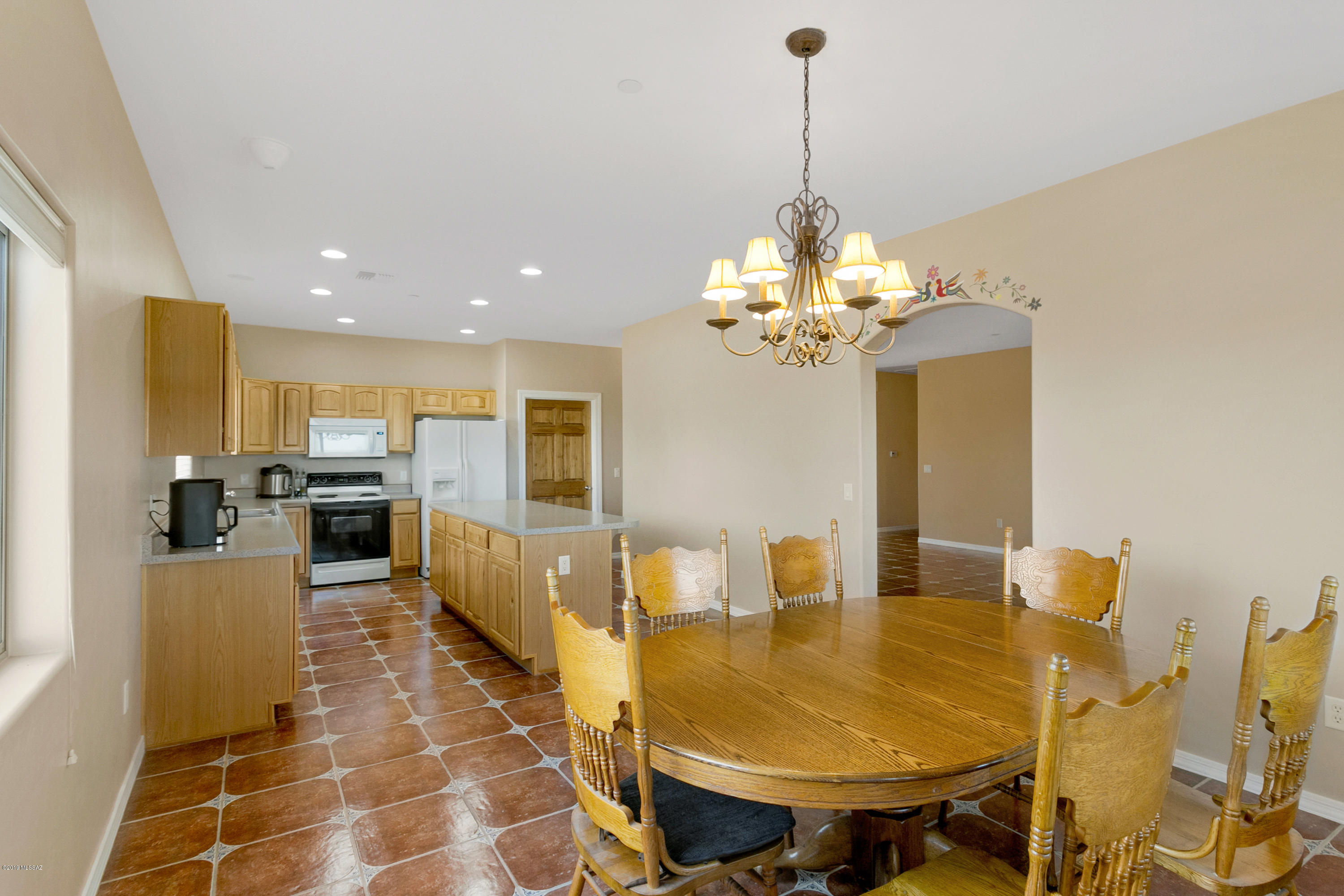 21960 South Helvetia Road Sahuarita, AZ 85629 - Photo 11 of 29 a view of a dining room with furniture and a chandelier