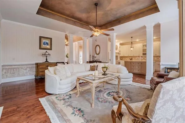a kitchen with stainless steel appliances granite countertop a stove and a white refrigerator with white cabinets