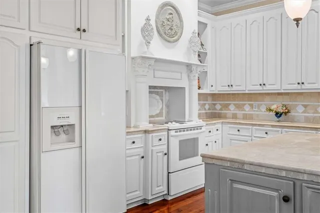 a kitchen with cabinets stainless steel appliances a sink and a window