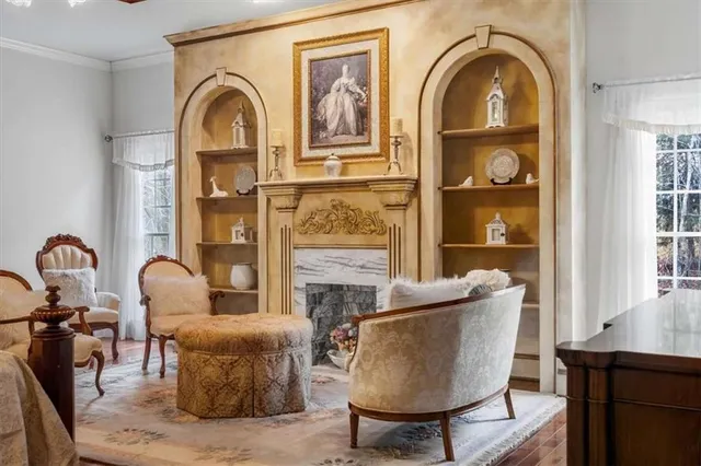 a living room with furniture fireplace and window