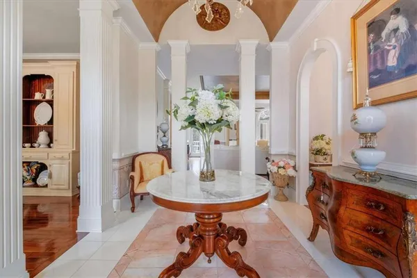 a living room with furniture and a chandelier