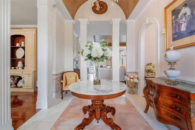 a living room with furniture and a chandelier