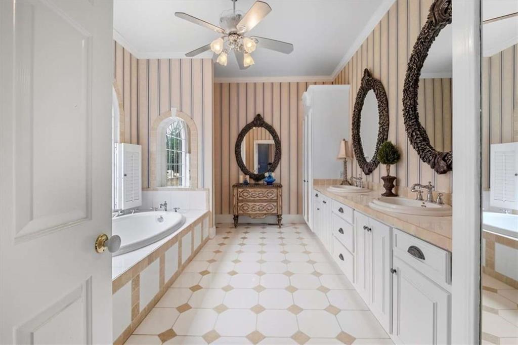 96 Windchime Way Northeast Rome, GA 30161 - Photo 31 of 57 a large bathroom with a double vanity sink a mirror and a bathtub