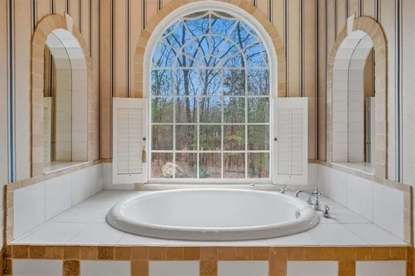 a bedroom with furniture and a large window