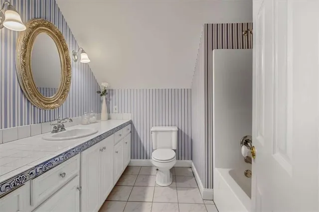 a bedroom with a bed window and a table