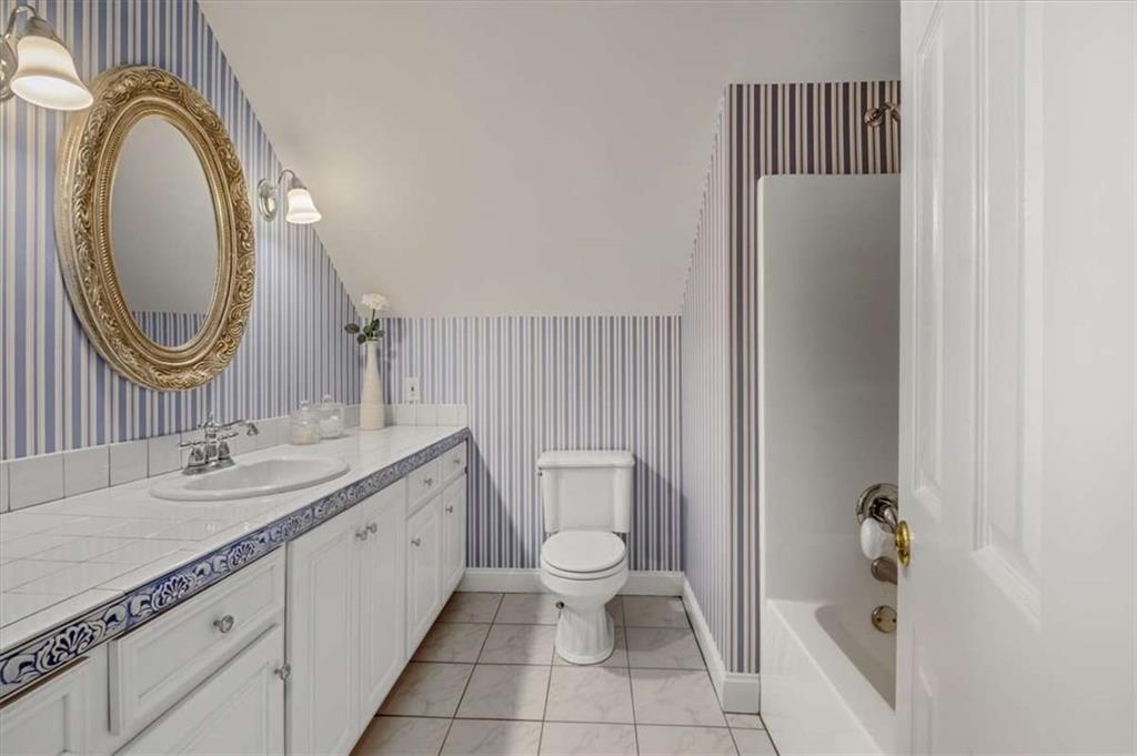 96 Windchime Way Northeast Rome, GA 30161 - Photo 45 of 57 a bathroom with a toilet a sink a mirror and a shower