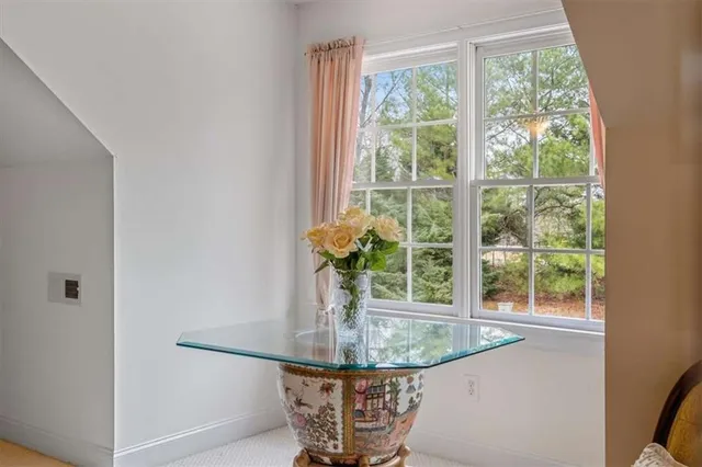 a front view of a house with a garden and trees