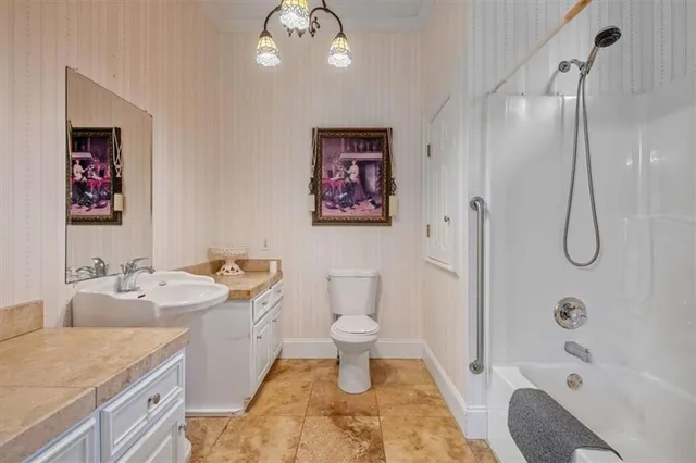 a front view of a house with a garden and mountain view