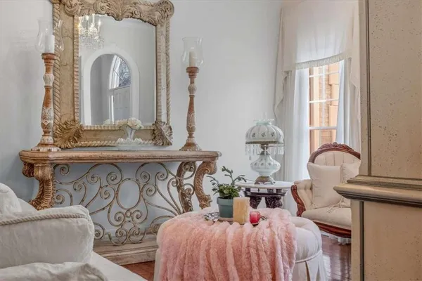 a view of a dining room with furniture a chandelier and wooden floor