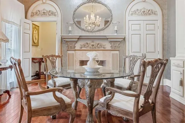 a living room with fireplace furniture and a chandelier