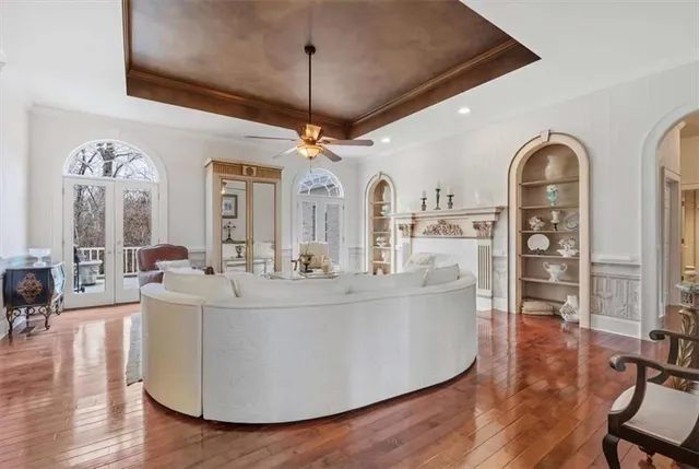 a living room with fireplace furniture and a wooden floor