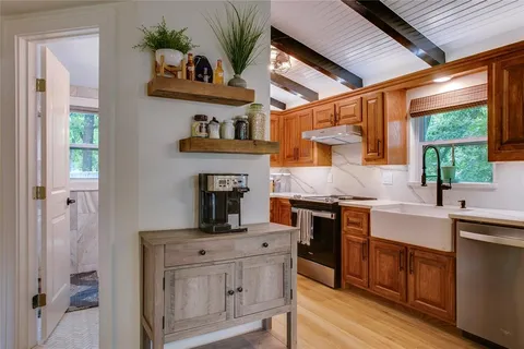 a kitchen with cabinets a window and appliances