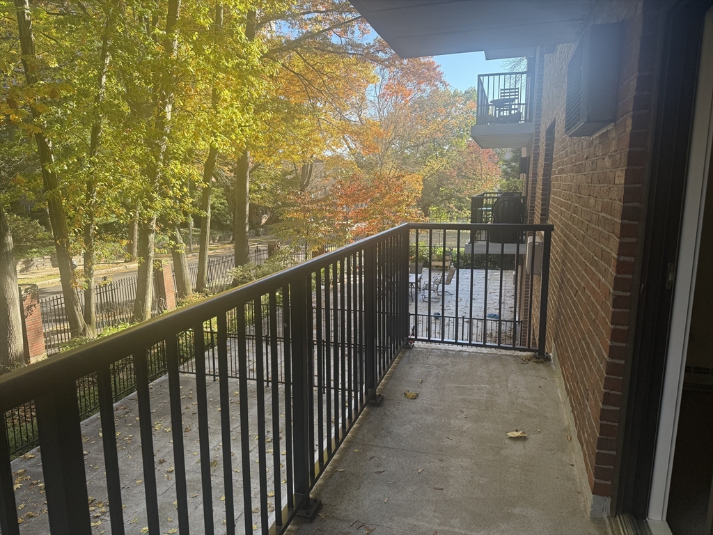 135 Pleasant Street, Unit 207 Brookline, MA 02446 - Photo 16 of 16 a view of a balcony with wooden floor
