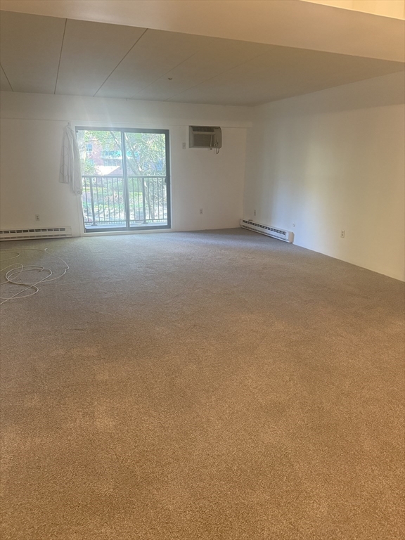 135 Pleasant Street, Unit 207 Brookline, MA 02446 - Photo 2 of 16 an empty room with windows