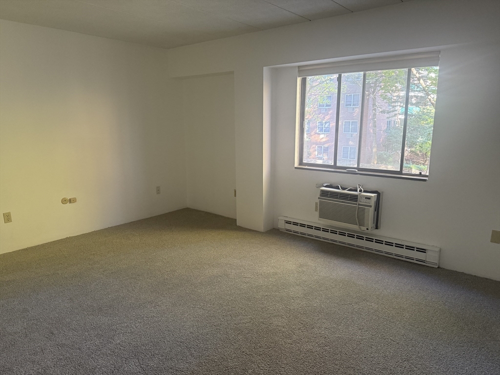 135 Pleasant Street, Unit 207 Brookline, MA 02446 - Photo 3 of 16 an empty room with windows