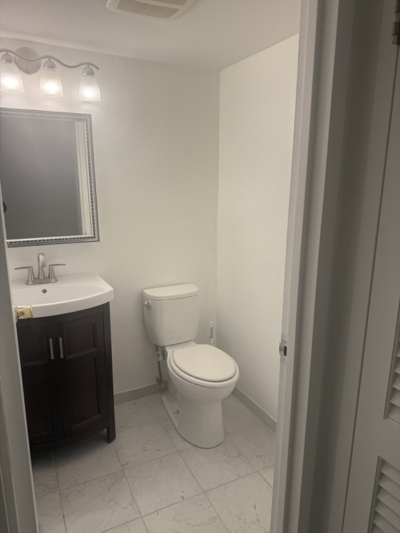 135 Pleasant Street, Unit 207 Brookline, MA 02446 - Photo 5 of 16 a bathroom with a sink and a toilet