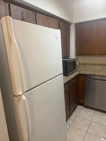 a white refrigerator freezer sitting in a kitchen