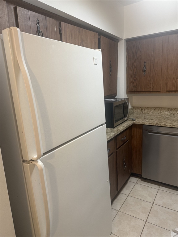 135 Pleasant Street, Unit 207 Brookline, MA 02446 - Photo 7 of 16 a white refrigerator freezer sitting in a kitchen