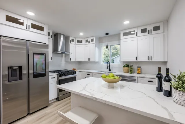 a kitchen with a stove a refrigerator and a sink
