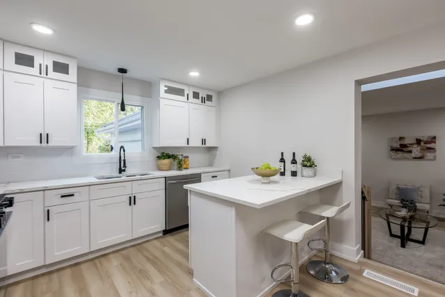 a kitchen with a sink cabinets and wooden floor