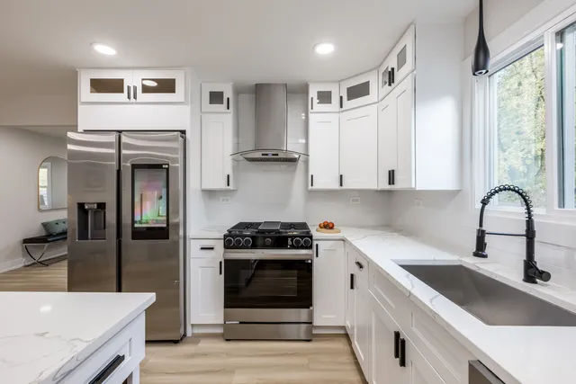a kitchen with stainless steel appliances granite countertop a stove and a sink