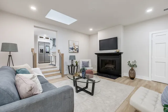 a living room with furniture a fireplace and a flat screen tv