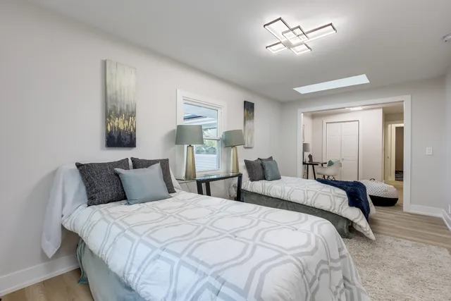 a bedroom with double bed and a chandelier