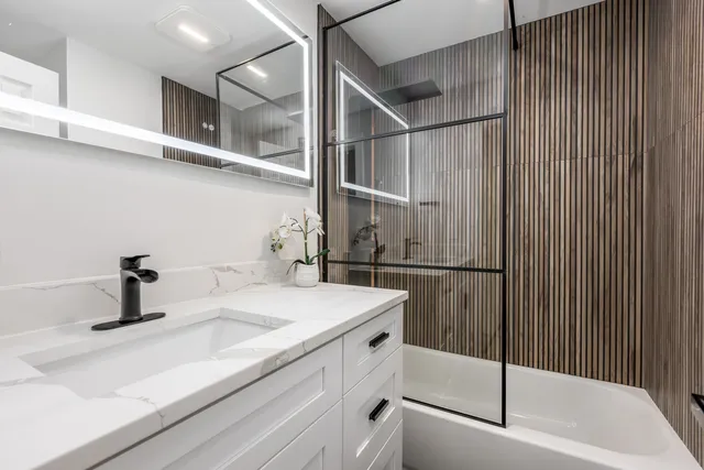 a bathroom with a sink and mirror