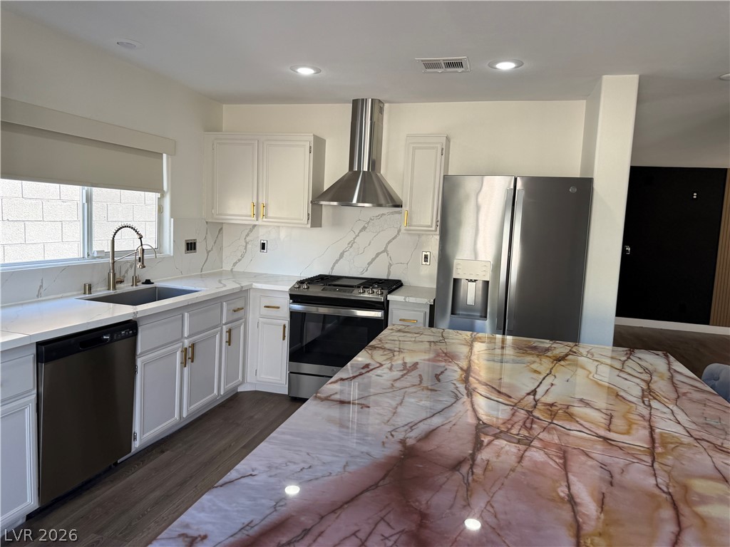 1141 Cathedral Ridge Street Henderson, NV 89052 - Photo 17 of 77 This modern kitchen features a spacious island and contemporary appliances, perfect for culinary endeavors.