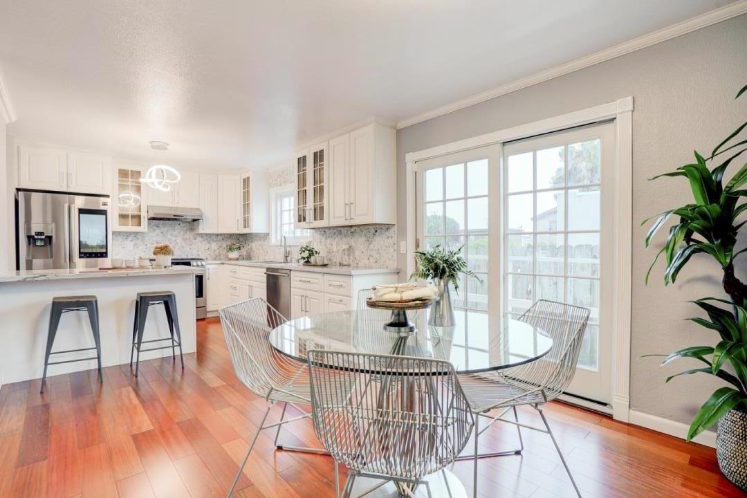 350 Buckingham Way Pacifica, CA 94044 - Photo 23 of 68 a kitchen with a table chairs and a stove
