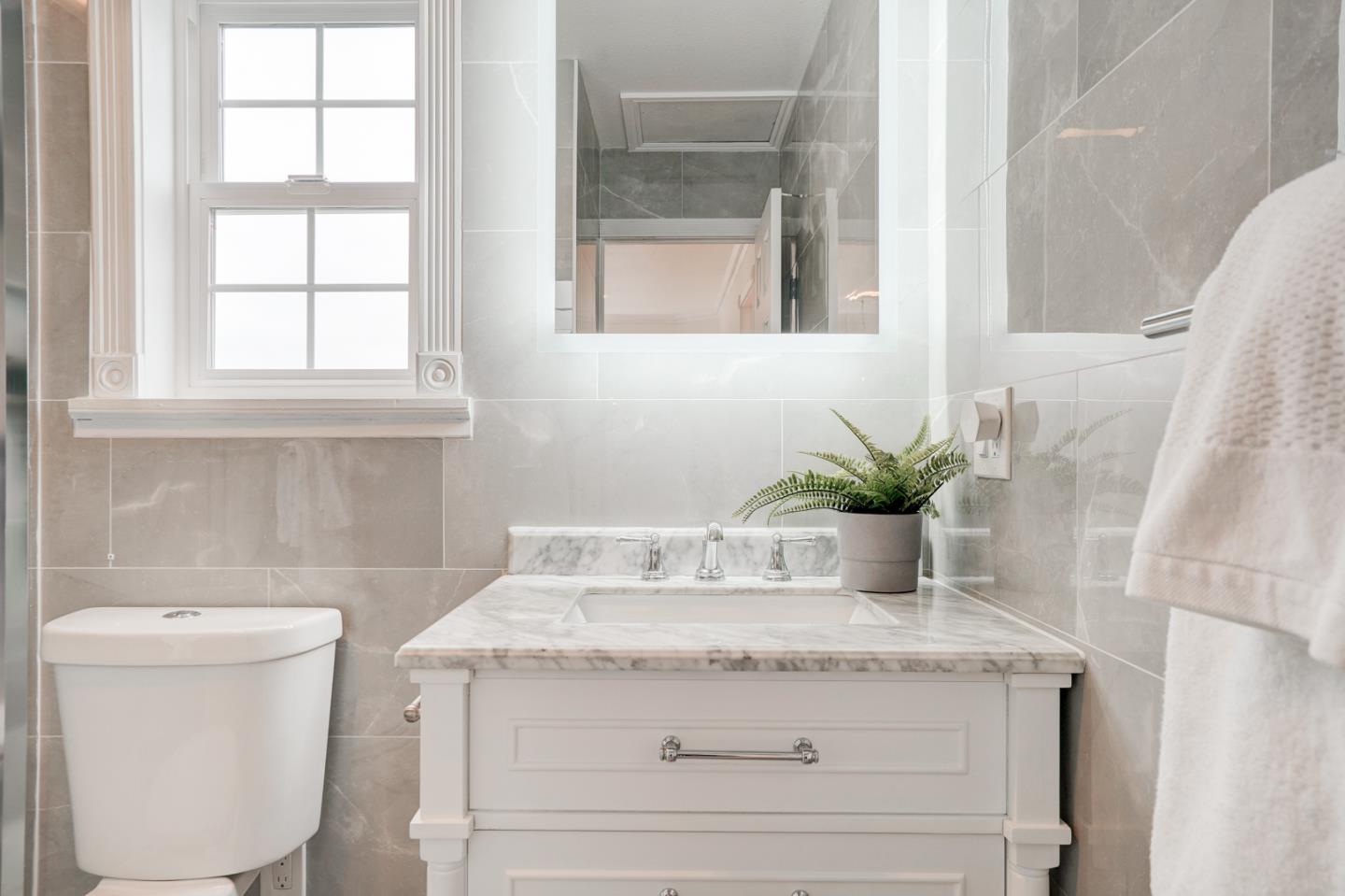 350 Buckingham Way Pacifica, CA 94044 - Photo 44 of 68 a bathroom with a granite countertop sink a toilet and a window
