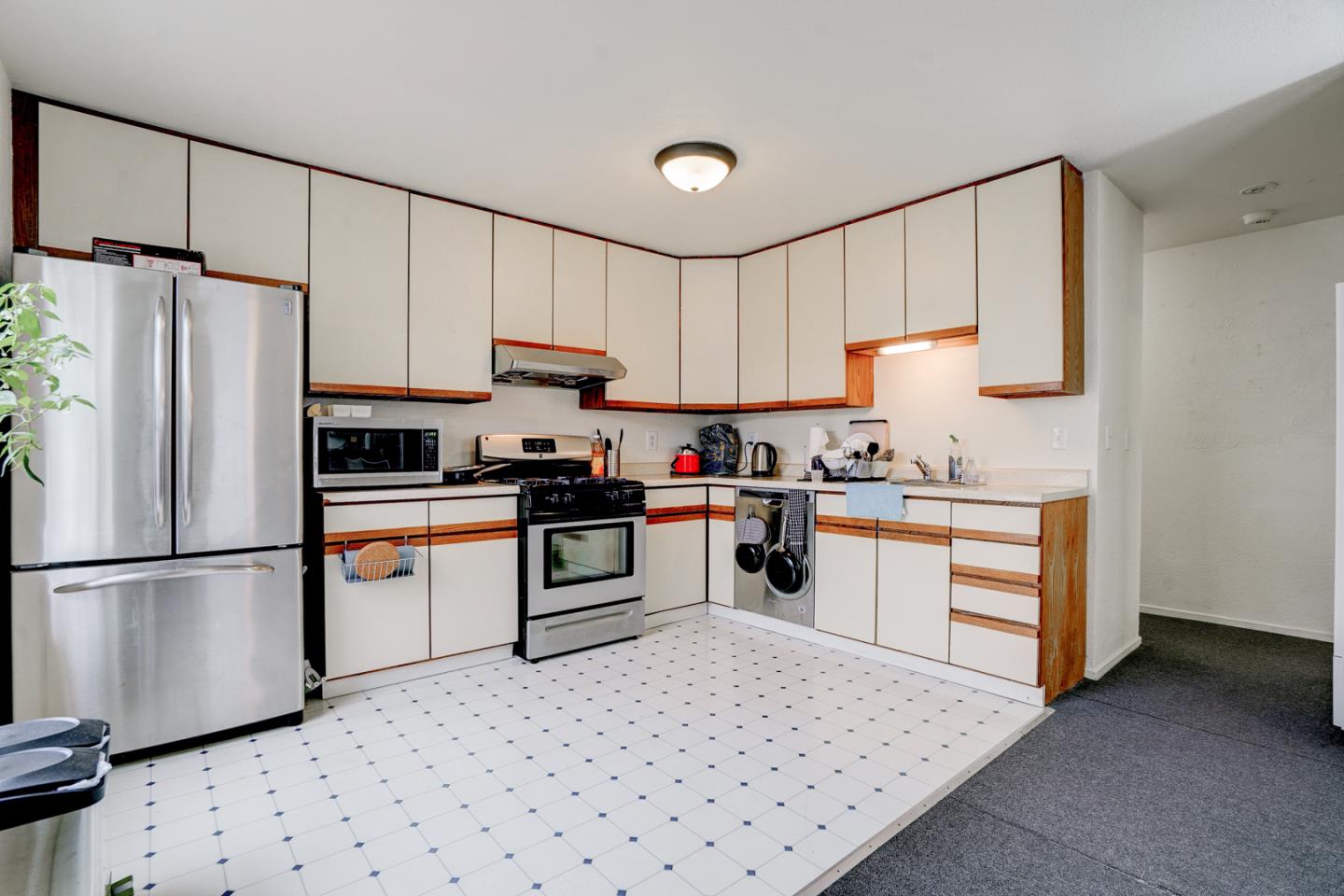 350 Buckingham Way Pacifica, CA 94044 - Photo 55 of 68 a kitchen with granite countertop a refrigerator sink stove and cabinets