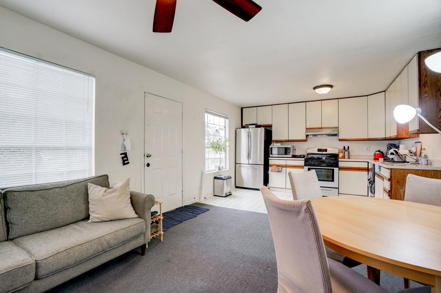 350 Buckingham Way Pacifica, CA 94044 - Photo 56 of 68 a living room with stainless steel appliances furniture a rug and a kitchen view