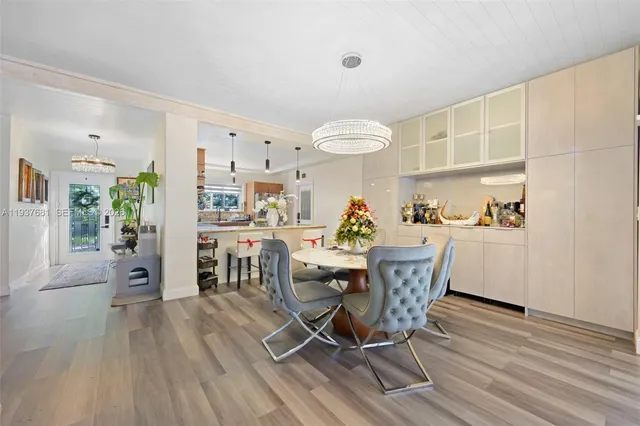 a dining room with furniture and wooden floor