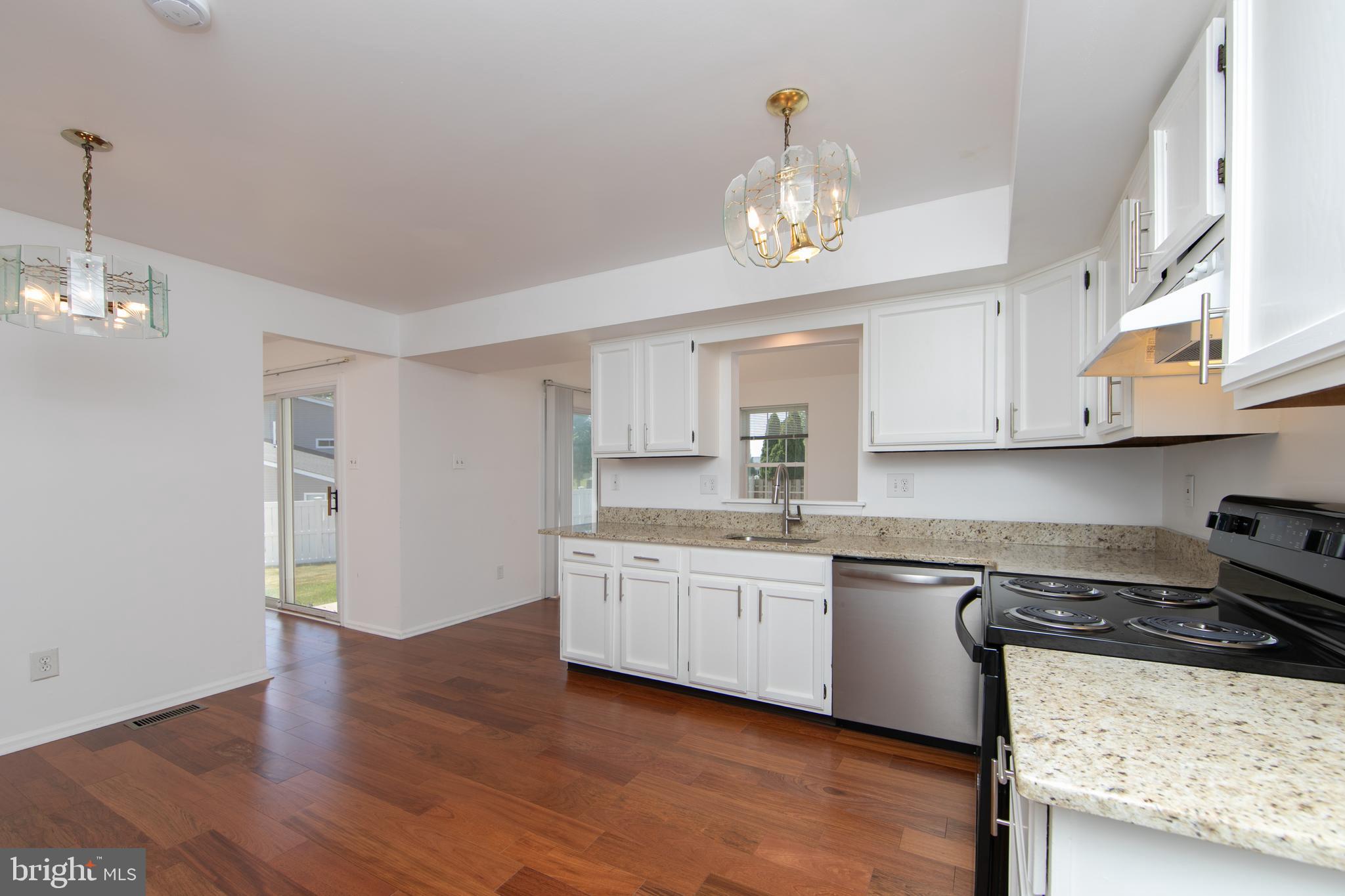 3007 Rampart Road Bensalem, PA 19020 - Photo 15 of 48 a kitchen with stainless steel appliances granite countertop a sink cabinets and wooden floor