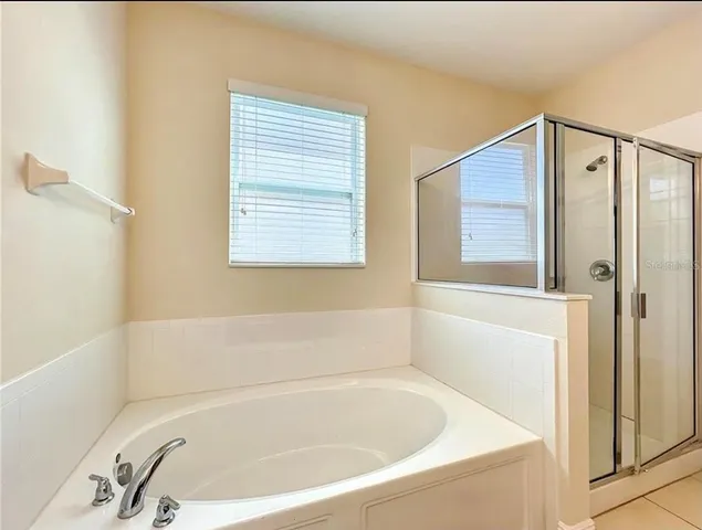 a white bath tub sitting next to a window