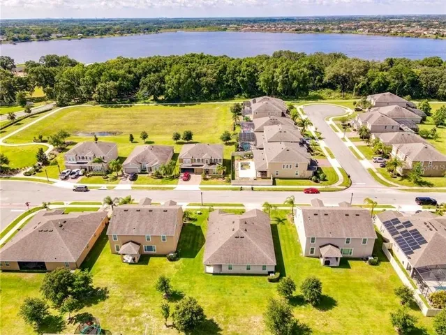 an aerial view of a house with a swimming pool and outdoor seating