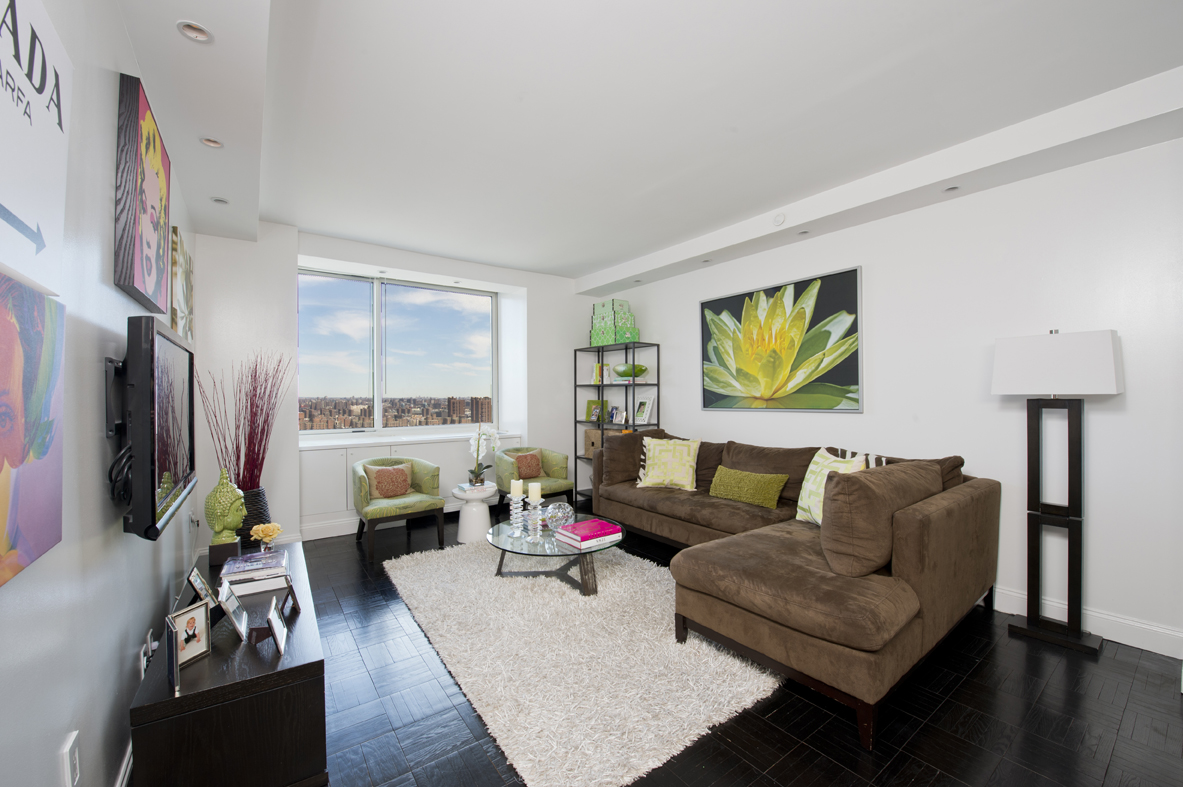 215-217 East 96th Street, Unit 33A Manhattan, NY 10128 - Photo 1 of 1 a living room with furniture fireplace and a flat screen tv