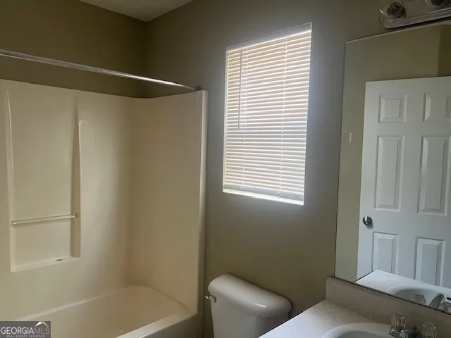a bathroom with a toilet and a bathtub