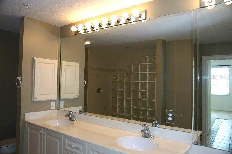 268 Lewis Circle, Unit 121 Punta Gorda, FL 33950 - Photo 16 of 27 a bathroom with a sink double vanity and a mirror