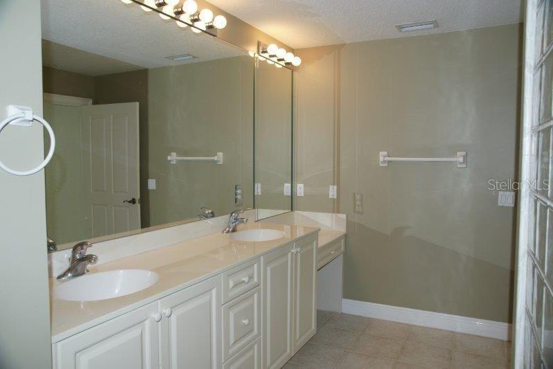 268 Lewis Circle, Unit 121 Punta Gorda, FL 33950 - Photo 18 of 27 a bathroom with a double vanity sink and a mirror