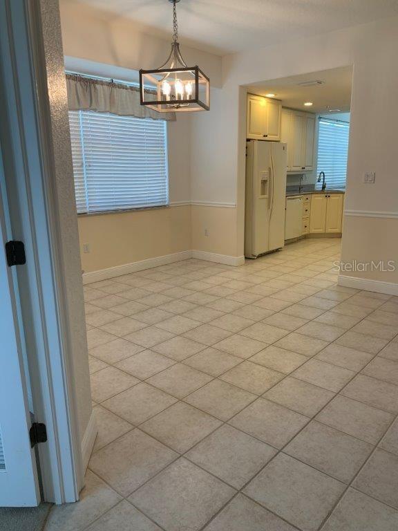 268 Lewis Circle, Unit 121 Punta Gorda, FL 33950 - Photo 20 of 27 a view of a hallway with a chandelier