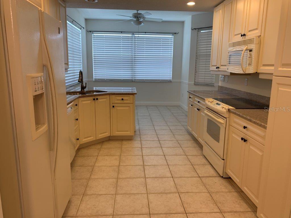 268 Lewis Circle, Unit 121 Punta Gorda, FL 33950 - Photo 22 of 27 a kitchen with stainless steel appliances granite countertop a stove a sink and a refrigerator