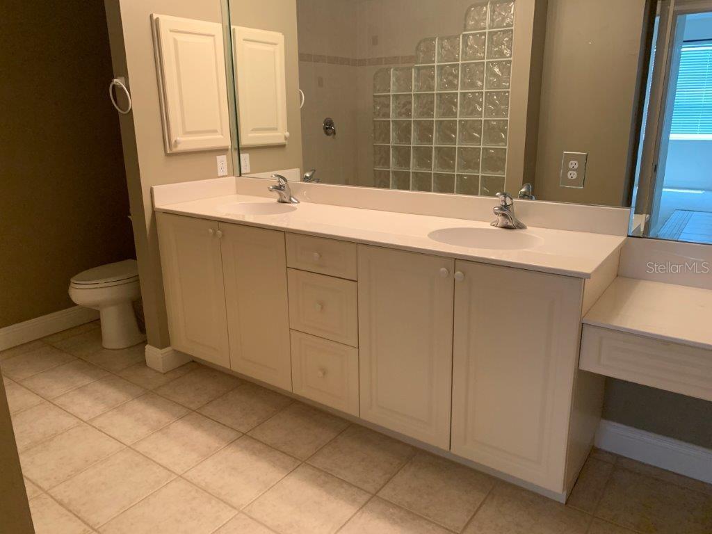 268 Lewis Circle, Unit 121 Punta Gorda, FL 33950 - Photo 26 of 27 a bathroom with a sink toilet and mirror