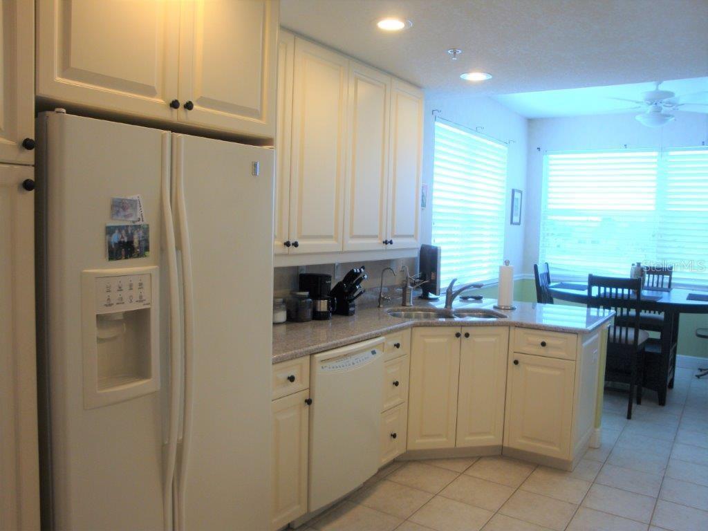 268 Lewis Circle, Unit 121 Punta Gorda, FL 33950 - Photo 5 of 27 a kitchen with white cabinets and appliances