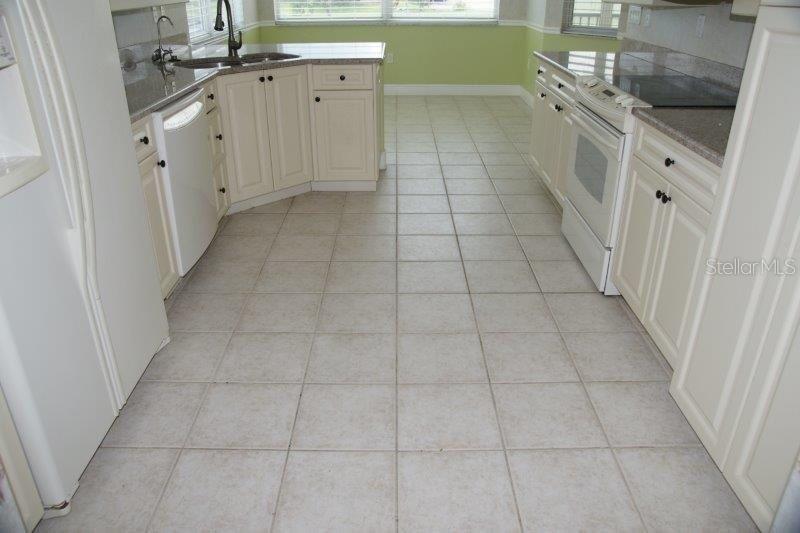 268 Lewis Circle, Unit 121 Punta Gorda, FL 33950 - Photo 10 of 27 a view of a kitchen with white cabinets