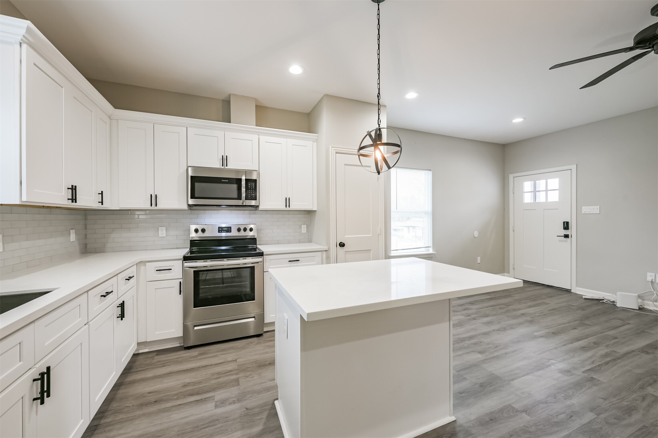 4405 Mallow Street Houston, TX 77051 - Photo 5 of 21 a large kitchen with cabinets wooden floor and stainless steel appliances
